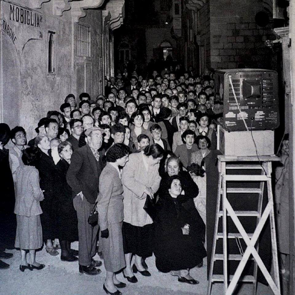 Maltese gather around to watch TV for the first time